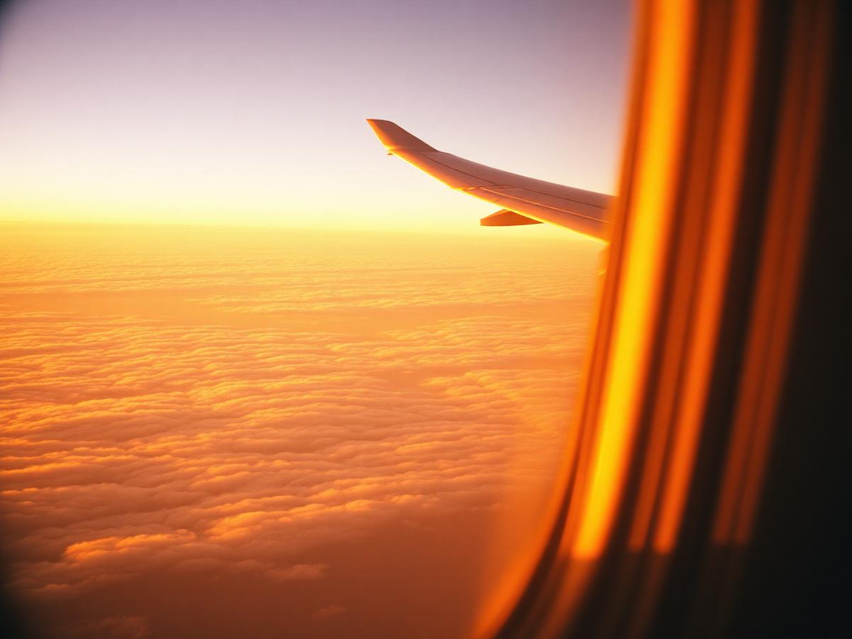 Golden-hour clouds seen from an airplane window